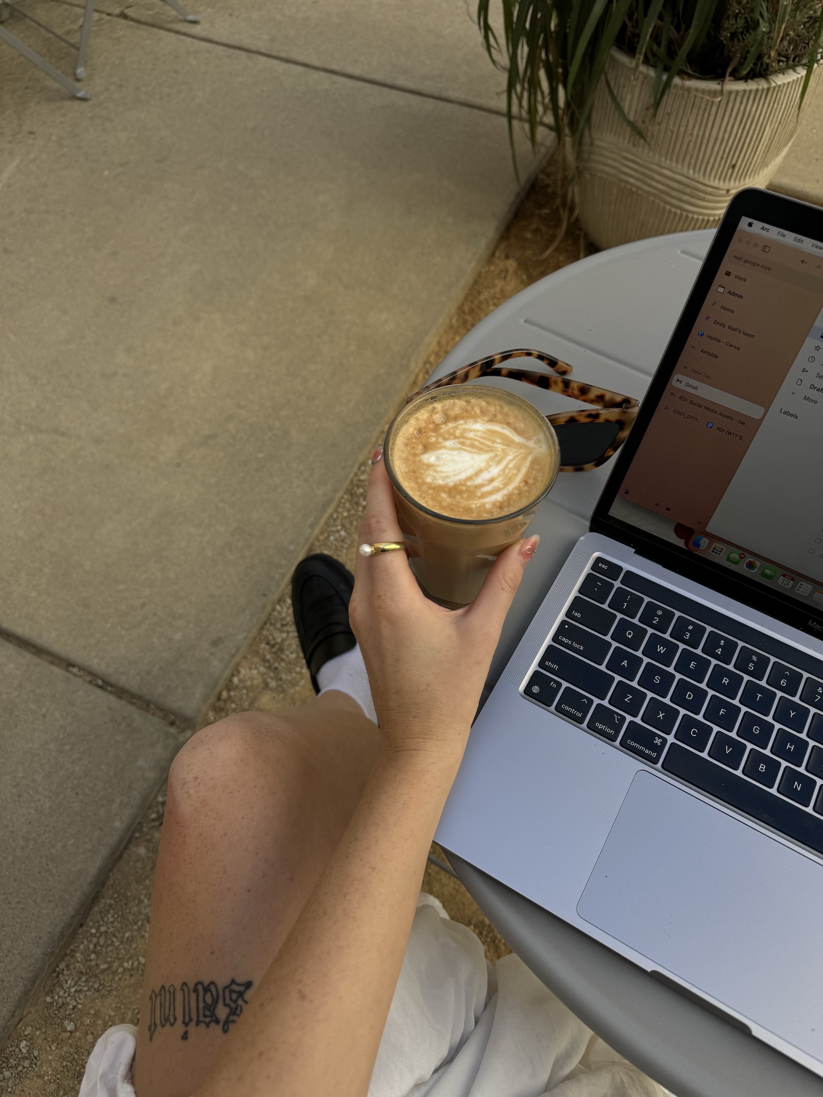 personal stylist drinking coffee and looking at her laptop